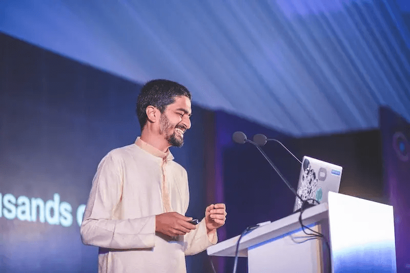 A React community speaker presenting on stage